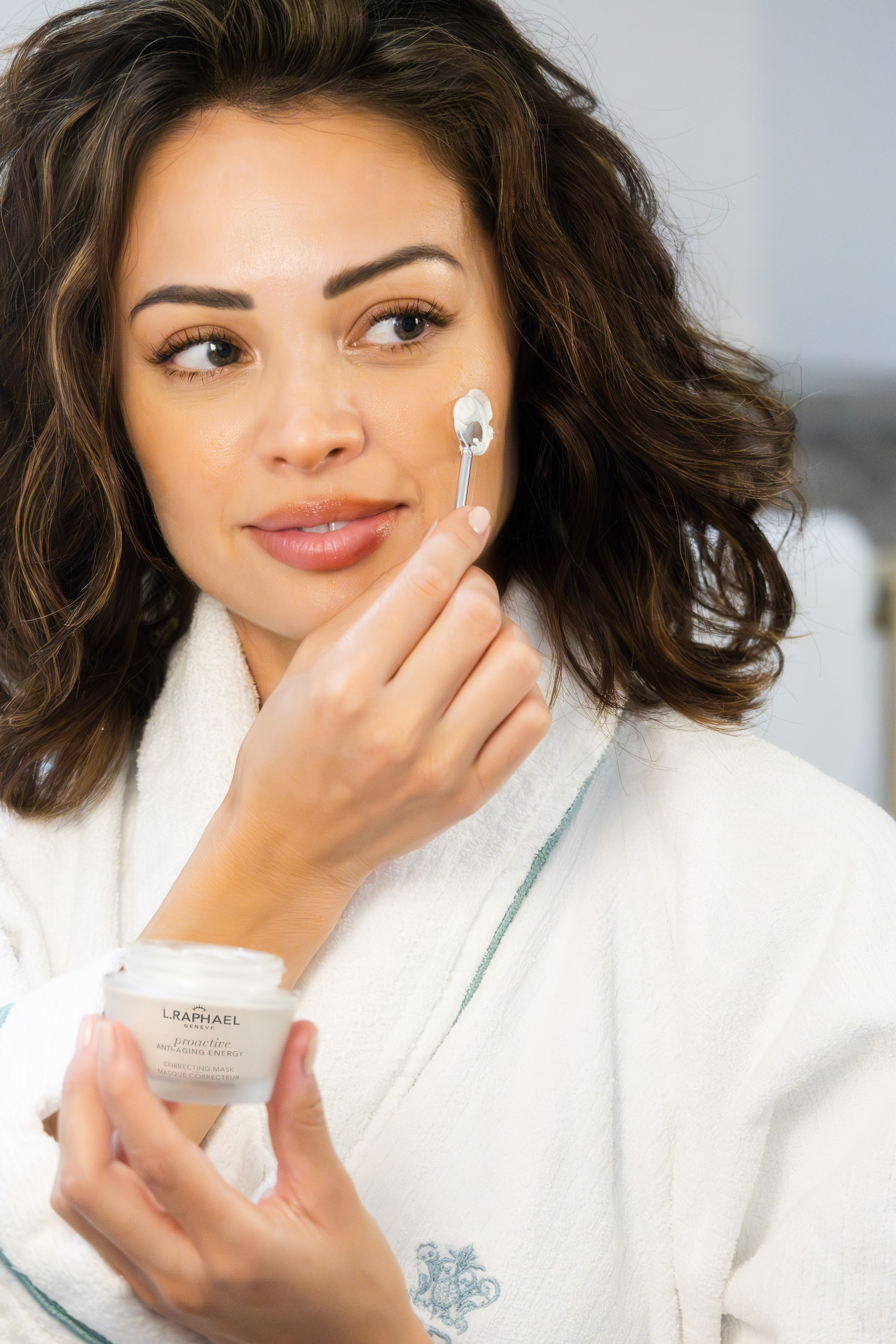 Woman applying face cream in luxury skincare routine