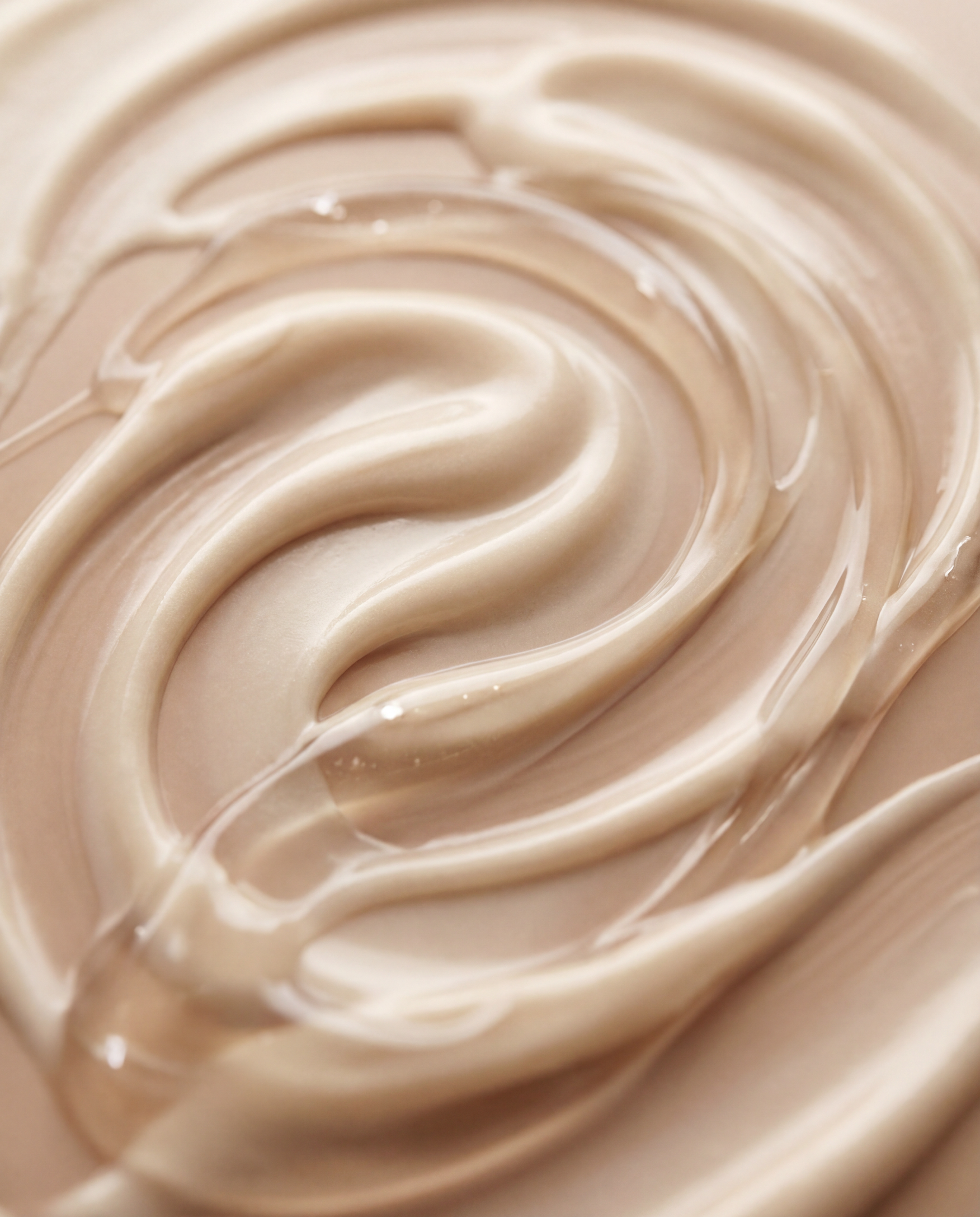 Close-up of smooth, beige cream with a swirling pattern