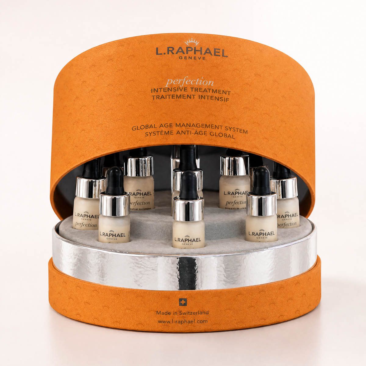 L.Raphael skincare product set on an orange and silver display stand.