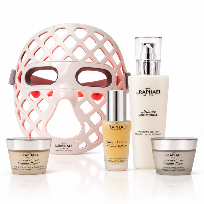 L'RAPEL GENEVE skincare set featuring a large white LED light therapy mask, a white anti-aging cream bottle, a beige cellular repair serum, and two white barrier repair creams, all arranged on a reflective white surface.