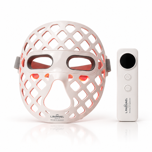 An LED light therapy mask in white with a cutout design, shown next to its white remote control on a clean white background. The brand name 'L.