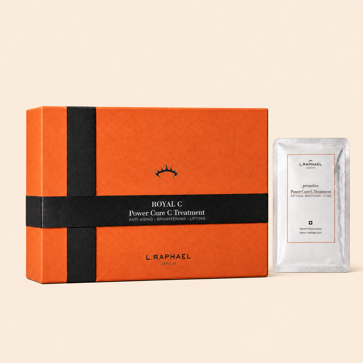 L. RAPHAEL Royal C Power Care C Treatment set, featuring an orange and black gift box alongside a single silver foil treatment sachet on a solid beige background.